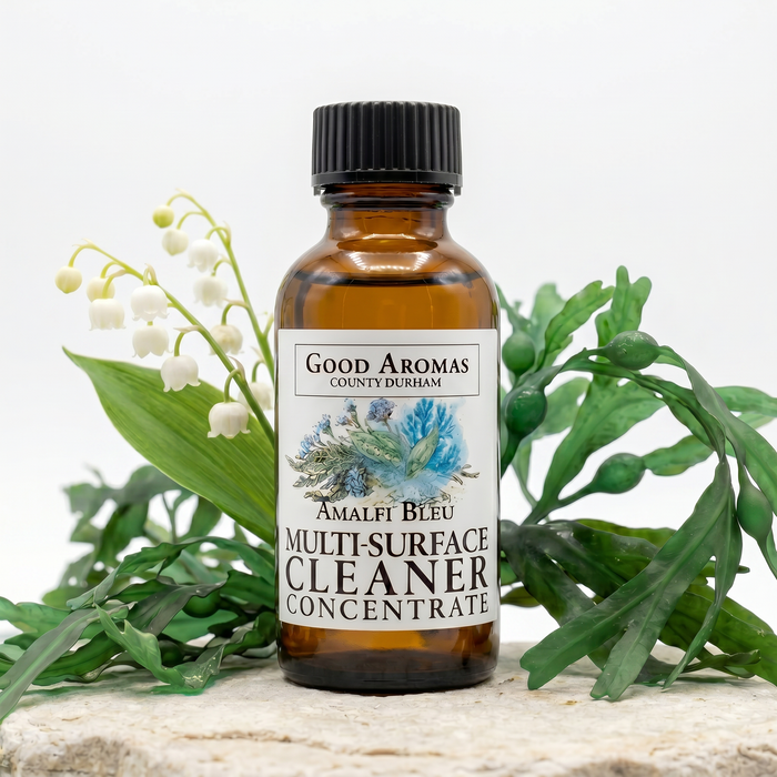 Bottle of Good Aromas multi-surface cleaner concentrate with greenery on a light background
